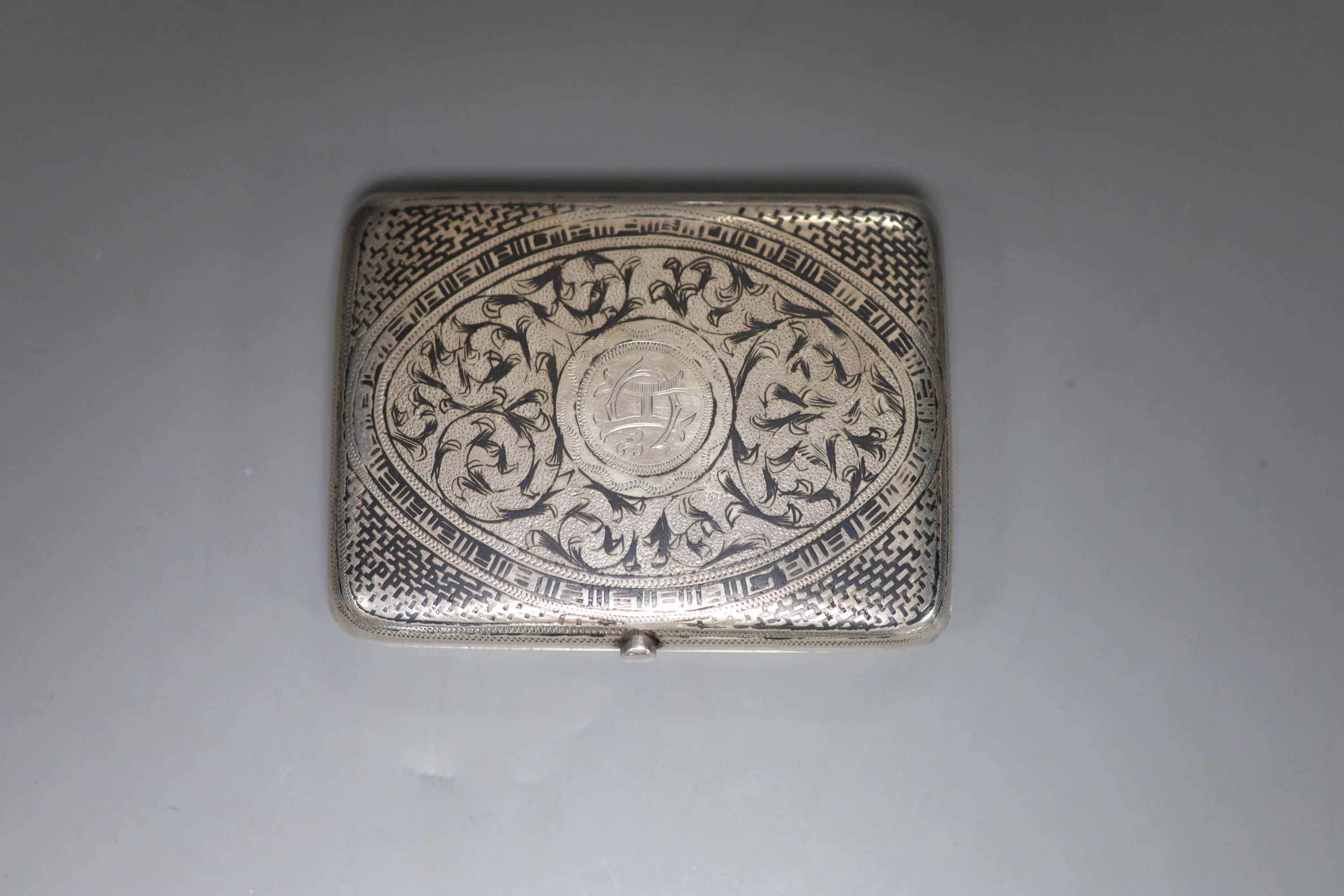 A late 19th century Russian 84 zolotnik and niello cigarette case, 89mm and an Austro-Hungarian 900 standard white metal and niello cigarette case, gross 7oz.